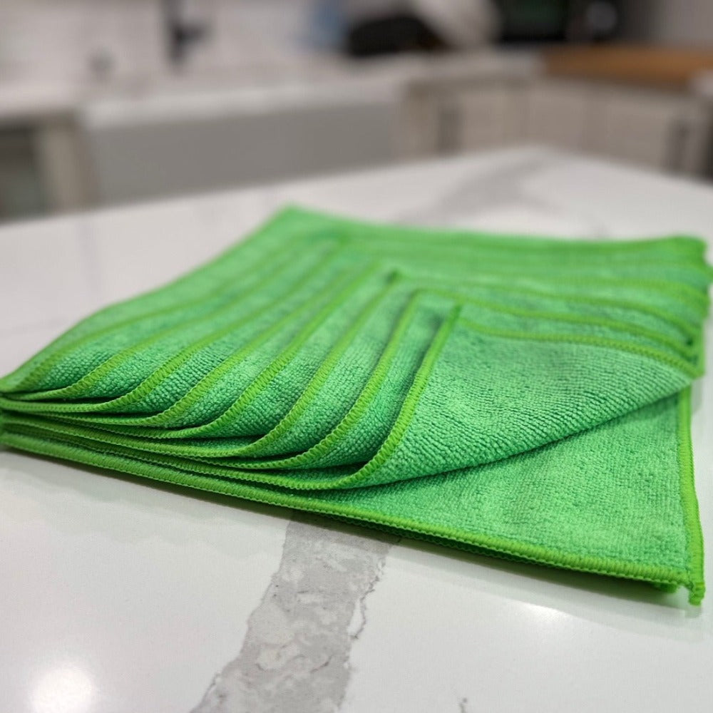 12 inch by 12 inch Green Life Saver Microfiber Cloths / towels 12 pack angled view on Quartz countertop