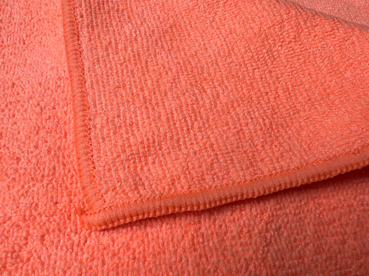 16 inch by 16 inch Orange Life Saver Max Cloths / towels  close-up view showing fabric thickness, texture and edges