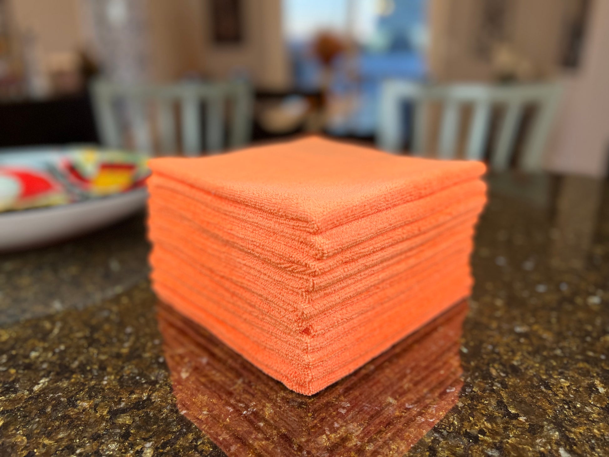 16 inch by 16 inch Orange Life Saver Max Cloths / towels 12 pack angled view on granite countertop